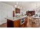 The kitchen features a central island with a marble countertop, modern appliances, and seamless integration with the living space at 13101 Whisper Creek Dr, Charlotte, NC 28277