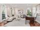 Elegant living room featuring arched windows, hardwood floors, and stylish decor for a sophisticated ambiance at 13101 Whisper Creek Dr, Charlotte, NC 28277