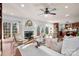 Bright living room showcases a fireplace, large windows, and an open layout that connects seamlessly with the kitchen at 13101 Whisper Creek Dr, Charlotte, NC 28277
