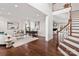 Bright, open-concept living space with hardwood floors, a comfortable seating area, and a home office setup at 13101 Whisper Creek Dr, Charlotte, NC 28277