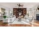 Bright living room features hardwood floors, custom built-ins, and neutral decor at 13101 Whisper Creek Dr, Charlotte, NC 28277