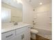 Bright bathroom featuring white cabinets, sink, framed mirror, tub, and toilet at 165 Halite Ln, Waxhaw, NC 28173