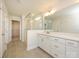 Bright bathroom features double vanity, tiled floors, glass shower, and a view into a walk-in closet at 165 Halite Ln, Waxhaw, NC 28173
