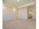 This large bedroom features neutral walls, recessed lights, plush carpet, and a view into a hallway at 165 Halite Ln, Waxhaw, NC 28173