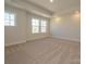 Bright bedroom features plush carpeting, neutral walls, recessed lights and large windows at 165 Halite Ln, Waxhaw, NC 28173