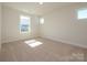 Bright bedroom with carpet flooring, large windows, and natural light at 165 Halite Ln, Waxhaw, NC 28173