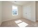 Cozy bedroom with neutral carpet, closet doors, and bright window at 165 Halite Ln, Waxhaw, NC 28173