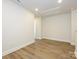Bonus room with light wood floors and white walls, ample lighting, and a view into another room at 165 Halite Ln, Waxhaw, NC 28173