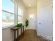 Bright and airy entryway boasts wood-look floors, ample natural light, and a convenient coat closet at 165 Halite Ln, Waxhaw, NC 28173
