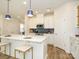 Beautiful kitchen with an expansive island, pendant lighting, stainless appliances, and crisp white cabinetry at 165 Halite Ln, Waxhaw, NC 28173