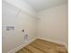Practical laundry room with vinyl flooring, utility sink and washer/dryer hookups at 165 Halite Ln, Waxhaw, NC 28173