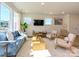 Comfortable living room with large windows, modern furniture, and warm wood-look flooring at 165 Halite Ln, Waxhaw, NC 28173