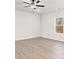 A large bedroom with wood floors, a ceiling fan, and a large window showcasing the wooded yard at 3250 Maple Ridge Dr, Gastonia, NC 28052