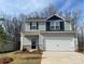 Charming two-story home featuring stone accents, a two-car garage, and a beautifully landscaped front yard at 3250 Maple Ridge Dr, Gastonia, NC 28052