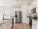 Bright kitchen featuring stainless steel appliances and granite countertops with a modern sink fixture at 3250 Maple Ridge Dr, Gastonia, NC 28052