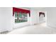 Light-filled room with carpet flooring, painted walls, large windows with red curtains, and visible doorways at 829 Rawlinson Rd, Rock Hill, SC 29732