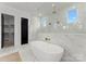 Modern bathroom featuring large soaking tub and marble-like tile at 1015 Kendall Dr # 4, Wesley Chapel, NC 28173