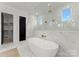 Bright bathroom with a soaking tub, glass-enclosed shower, and stylish marble accents at 1015 Kendall Dr # 4, Wesley Chapel, NC 28173