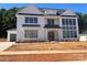 A Modern farmhouse with white siding, black trim and metal roof accents stands out at 1015 Kendall Dr # 4, Wesley Chapel, NC 28173