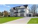 Striking Modern Farmhouse with verdant lawn, long driveway and attached two-car garage at 1015 Kendall Dr # 4, Wesley Chapel, NC 28173