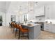 Bright, open kitchen with white cabinets, an island with seating, and pendant lighting at 1015 Kendall Dr # 4, Wesley Chapel, NC 28173