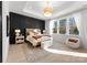 A light, bright main bedroom featuring a wainscot accent wall and large window seating area at 1015 Kendall Dr # 4, Wesley Chapel, NC 28173