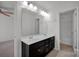 Shared bathroom with double vanity and dark wood cabinets at 10436 Paisley Abbey Ln, Charlotte, NC 28273