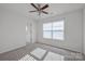 Well-lit bedroom with neutral walls, carpet, and ceiling fan at 10436 Paisley Abbey Ln, Charlotte, NC 28273