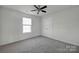 Well-lit bedroom with carpet and ceiling fan at 10436 Paisley Abbey Ln, Charlotte, NC 28273