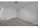 Well-lit bedroom with double doors and carpet at 10436 Paisley Abbey Ln, Charlotte, NC 28273