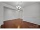 Formal dining room with hardwood floors, wainscoting, and chandelier at 10436 Paisley Abbey Ln, Charlotte, NC 28273