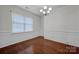 Formal dining room with hardwood floors, wainscoting, and chandelier at 10436 Paisley Abbey Ln, Charlotte, NC 28273