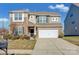 Two-story house with stone and siding accents, two-car garage, and landscaped lawn at 10436 Paisley Abbey Ln, Charlotte, NC 28273