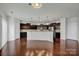 Kitchen boasts dark cabinetry, granite countertops and stainless steel appliances at 10436 Paisley Abbey Ln, Charlotte, NC 28273