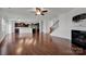 Open concept kitchen with island, hardwood floors and dark cabinets at 10436 Paisley Abbey Ln, Charlotte, NC 28273