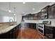 Modern kitchen with granite countertops and stainless steel appliances at 10436 Paisley Abbey Ln, Charlotte, NC 28273