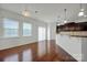 Kitchen features island, hardwood floors, and dark cabinets at 10436 Paisley Abbey Ln, Charlotte, NC 28273