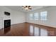 Living room features hardwood floors, fireplace and ceiling fan at 10436 Paisley Abbey Ln, Charlotte, NC 28273