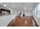 Spacious living room featuring hardwood floors, a fireplace, and ample natural light at 10436 Paisley Abbey Ln, Charlotte, NC 28273