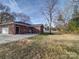 Large backyard with a grassy area and mature trees at 131 Nantz Ave, Mount Holly, NC 28120