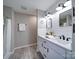 Bathroom with double vanity, white cabinets, and shiplap feature wall at 131 Nantz Ave, Mount Holly, NC 28120