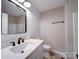 Simple bathroom with single vanity and white cabinets at 131 Nantz Ave, Mount Holly, NC 28120