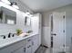 Double vanity bathroom with modern fixtures and a view into another room at 131 Nantz Ave, Mount Holly, NC 28120