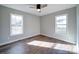 Bright bedroom with hardwood floors and two large windows at 131 Nantz Ave, Mount Holly, NC 28120