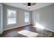 Bright bedroom with hardwood floors and two large windows at 131 Nantz Ave, Mount Holly, NC 28120