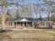 Brick ranch house with a covered porch and landscaped yard at 131 Nantz Ave, Mount Holly, NC 28120