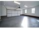 Spacious garage with painted floor and ample storage at 131 Nantz Ave, Mount Holly, NC 28120