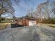 Rear view of house showing the attached garage and driveway at 131 Nantz Ave, Mount Holly, NC 28120