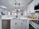 Modern kitchen with white cabinets and a farmhouse sink at 131 Nantz Ave, Mount Holly, NC 28120