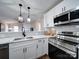 Modern kitchen with white cabinets and quartz countertops at 131 Nantz Ave, Mount Holly, NC 28120